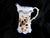 This is a Burslem marked pitcher in white with a blue, gold and pink leaf design and a blue trim. The porcelain is very...