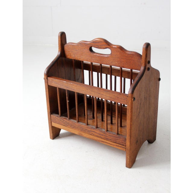 This vintage American oak magazine rack, crafted with a classic spindle design, adds rustic charm and functional storage...