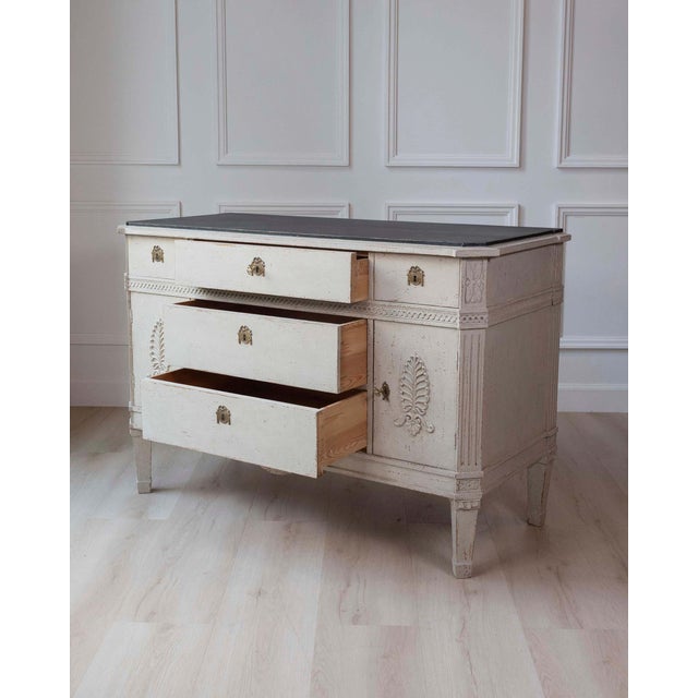 A Swedish sideboard inspired by 18th-century Baroque design, crafted in pine and finished in a softly aged cream paint...