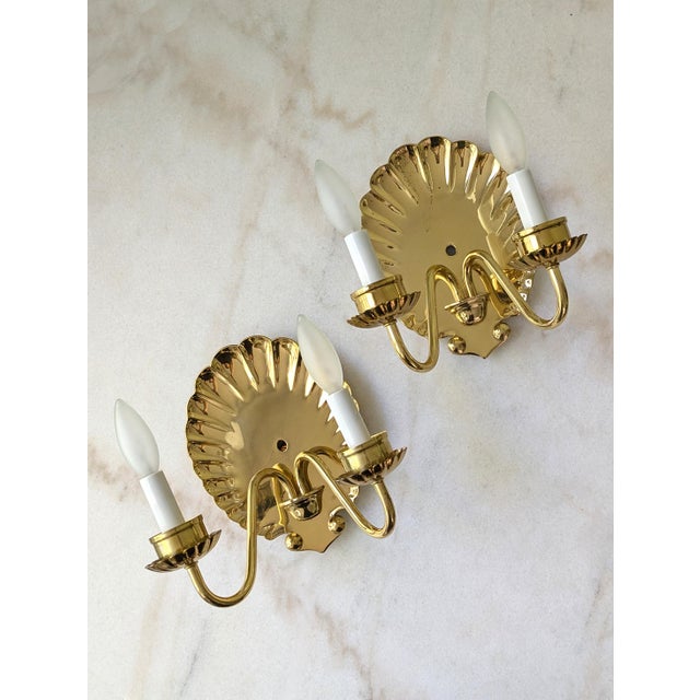 A pair of Mid Century Hollywood Regency style electrical wall sconces. The lamps were originally purchased from the...