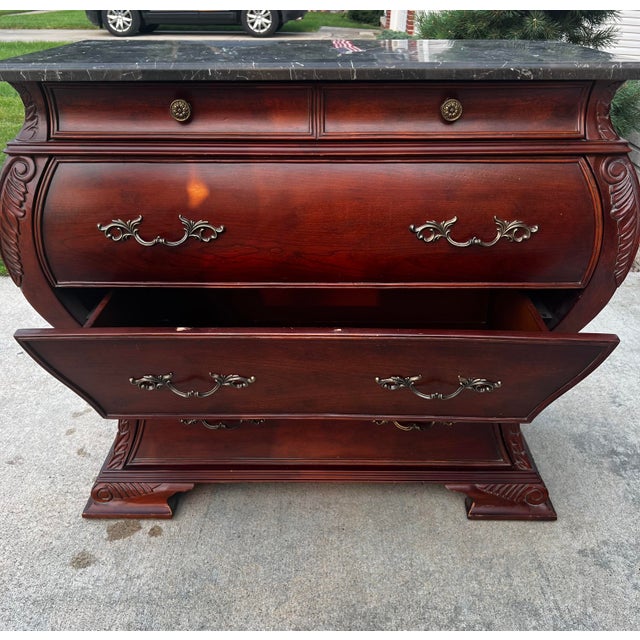 A Bombay® Furniture Co. Marble Top Bombe Chest in a Classic French
