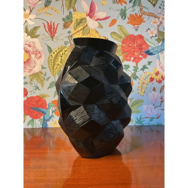 An elegant black vase by Lalique, showcasing the brand’s iconic artistry and refined craftsmanship. This signed and...