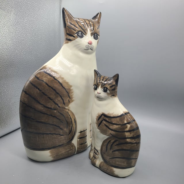 A pair of cute whimsical NS Gustin ceramic staffordshire style cats. The cats have shiny exterior that make them look like...