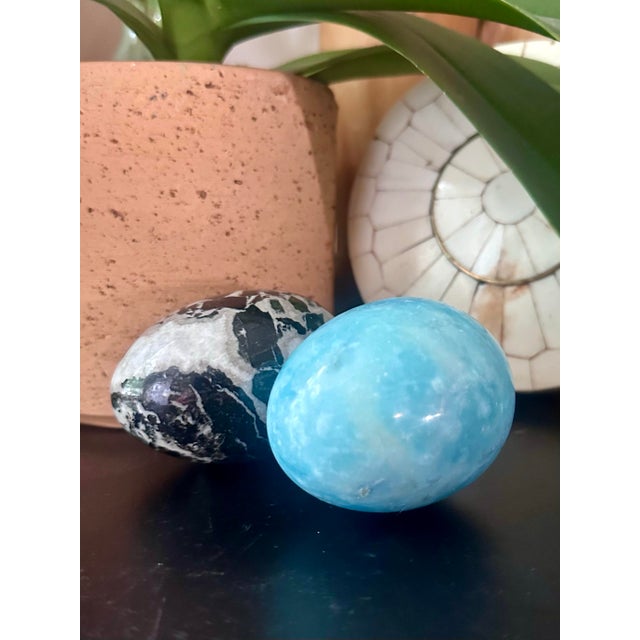This decorative crystal egg set includes one polished Caribbean Calcite egg and one Zebra Jasper egg. Beautifully carved...