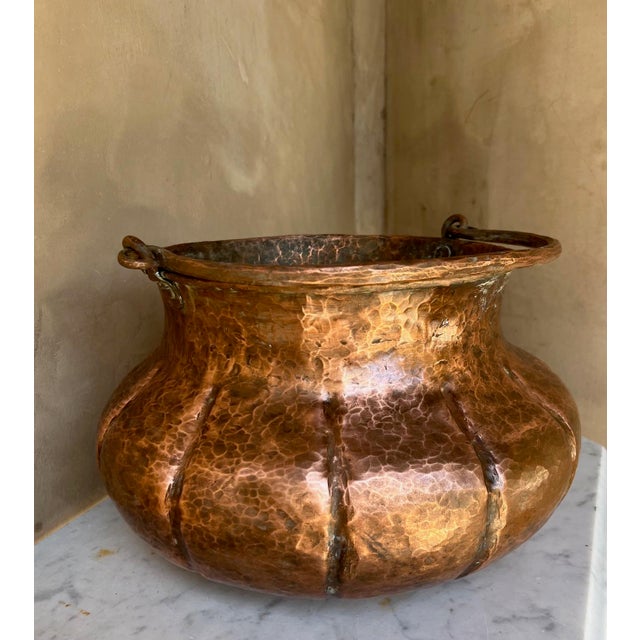 Large antique hammered copper cauldron with handle. Uniquely shaped, larger in the middle than the top and base. Great for...
