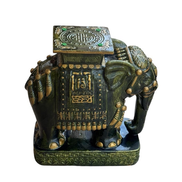 Stunning Hollywood Regency ceramic hand painted glazed emerald green elephant with gold accents. It can be use as garden...