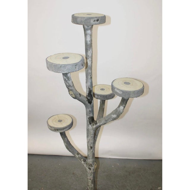 An evocative and sculptural French faux bois plant stand, exquisitely modeled to resemble a branching tree trunk with...