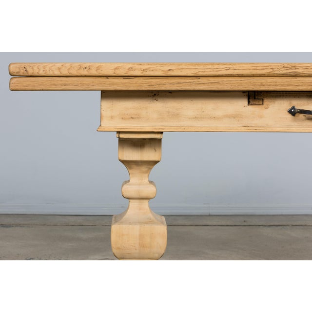 A lovely French Country Louis XIII style trestle table in a beautifully bleached wood finish, dating to the mid 20th...