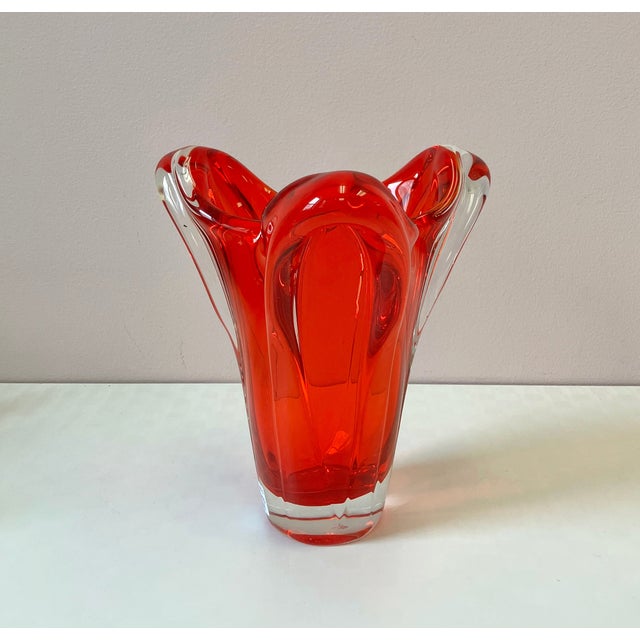 A stunning vibrantly colored freeform chunky glass vase in a deep red color with clear glass casing. C.1950's. Dimensions:...