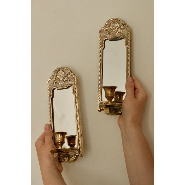 Made in Sweden. A stunning pair of mid-century hand crafted hammered heavy brass sconces with mirror. Despite their age,...