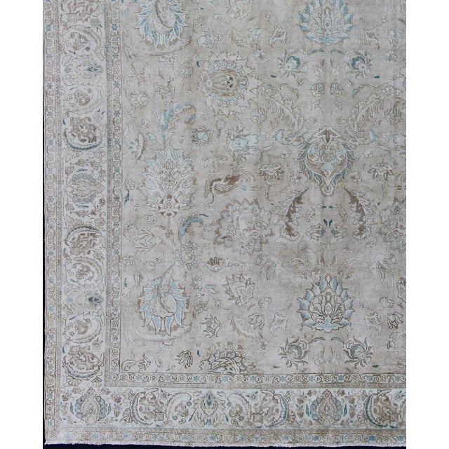 Measures: 9'8 x 12'6 Vintage Tabriz Rug with Soft Floral Medallion Design in Neutral Distressed Tones. Keivan Woven Arts/...