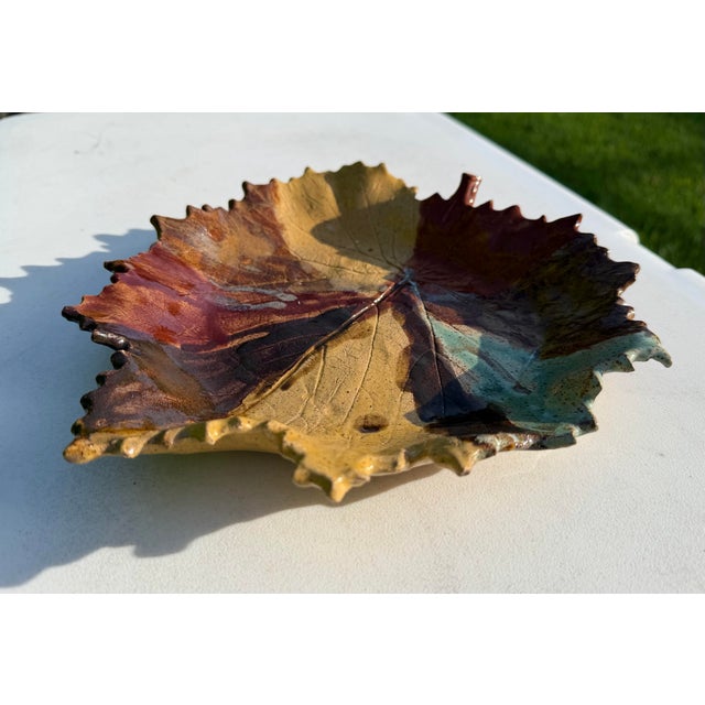 Striking signed studio pottery dish formed in the shape of a large leaf, with deeply impressed veining and an irregular...