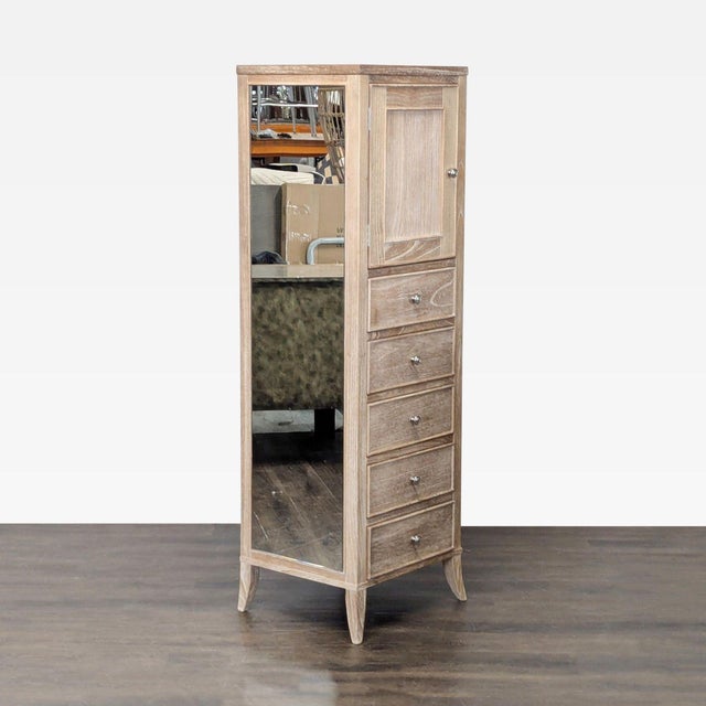 This Arhaus dresser features a tall, slim design with a light wood finish. It has five spacious drawers for ample storage...
