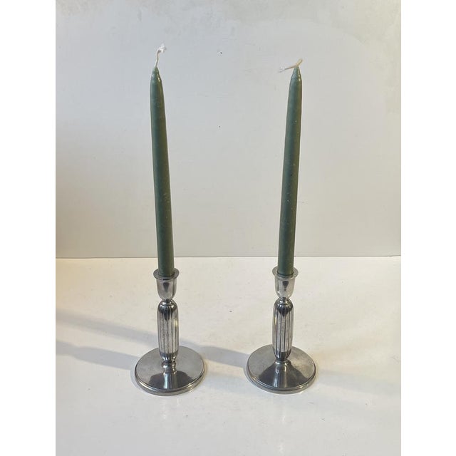 A pair of candlesticks designed by sculptor just andensen in denmark during the 1930s or 1940s. They are made from the...