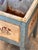 A cheerful painted cellaret converted to use as a planter, in powder blue with folk-painted panels on each face depicting...