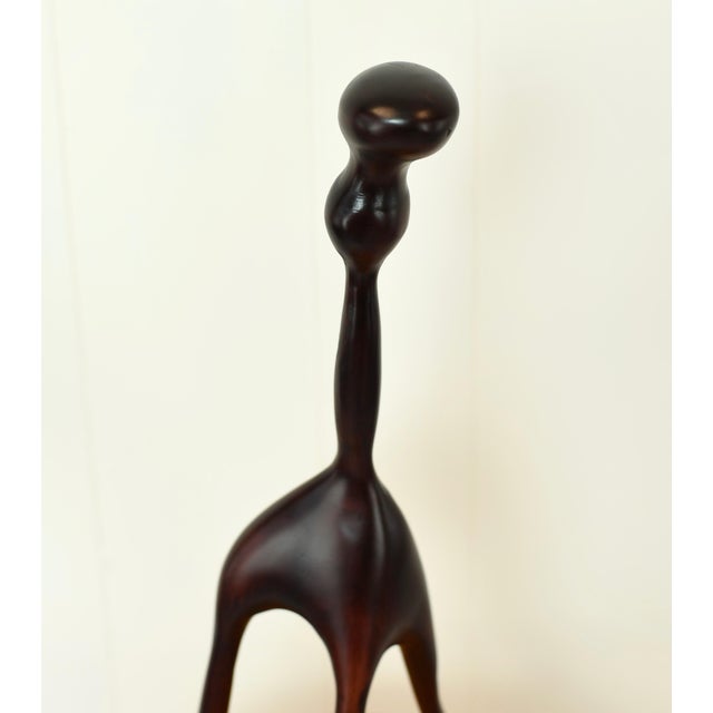 Modernist sculpture of one carved piece of wood. Measurements: Height: 18.5" Width: 8.5"
