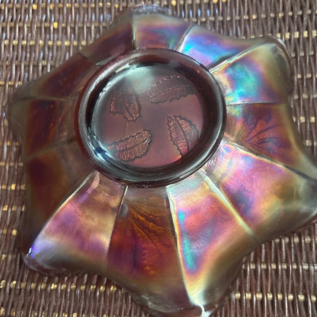 Fenton Thistle Ruffled Bowl with good iridescence and has an amber bottom. It dates to 1910.