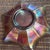 Fenton Thistle Ruffled Bowl with good iridescence and has an amber bottom. It dates to 1910.