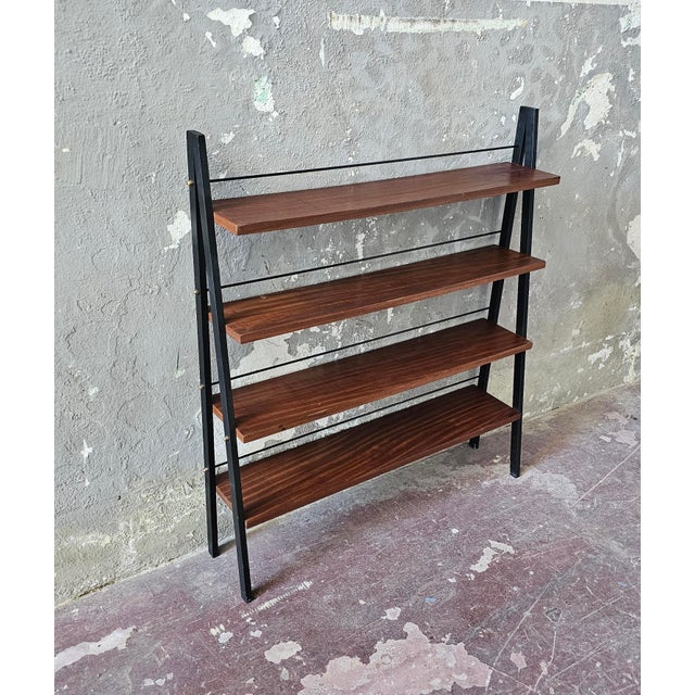 Small and elegant bookcase made of iron with teak shelves. Excellent overall condition with slight signs of wear.