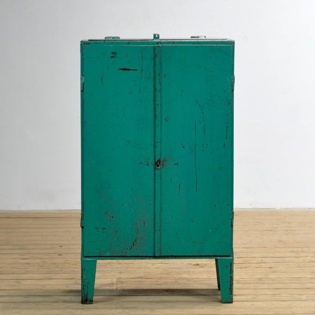Industrial cabinet from the 1970s, made of iron. This robust eye-catcher has a practical top flap and offers a surprising...