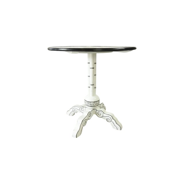 The round white tabletop is hand-painted with delicate deer and tree motifs, outlined in black, creating a unique retro...