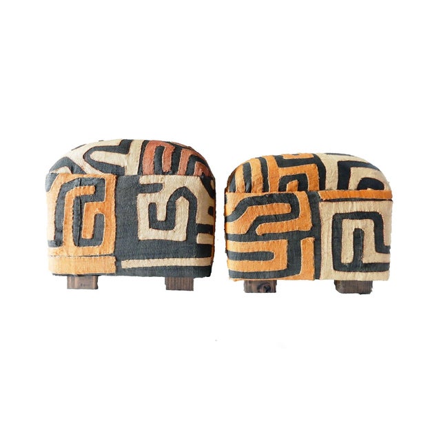 This set includes two square ottomans upholstered with Kuba textiles inspired by Matisse, crafted from raffia in Central...