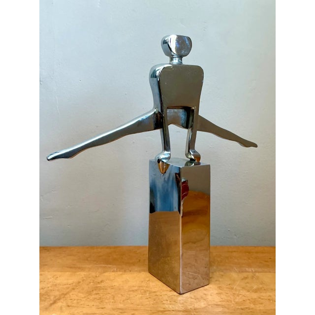 Sculpted with dynamic athletic balance and sleek minimalist lines, this vintage mid-century modern figurative sculpture...
