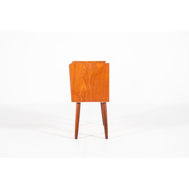 A lovely and simple bedside table made in Denmark in the 1960s. It has one pull-out drawer with a handle-free front and an...