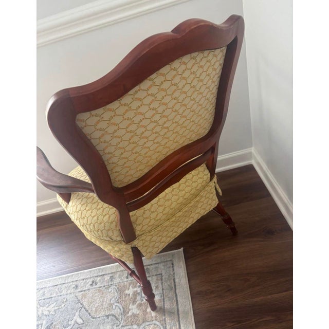 This armchair, likely from the early 19th century, showcases the robust and elegant design typical of the period. Its...