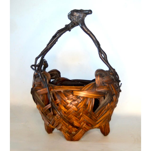A sculptural Japanese ikebana basket from the late Meiji period, featuring a four-legged base, with an organic natural...