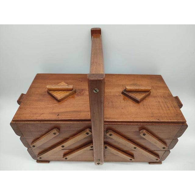 This exquisite vintage cantilever sewing box combines functional German craftsmanship with timeless mid-century design....