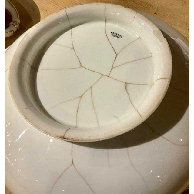 Elegant china service by Cauldon, pattern number 7477, made for James Green, a London retailer. There is a slight...