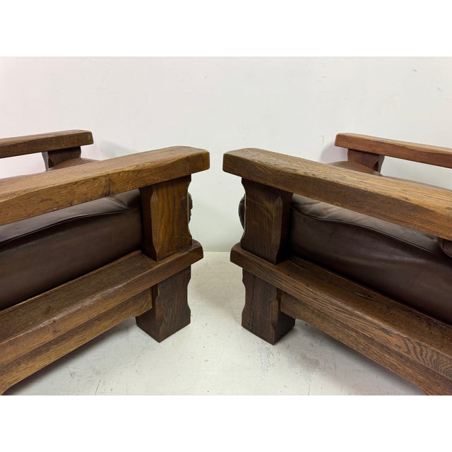 Pair of brutalist armchairs This is a striking pair of heavy oak Brutalist armchairs, showcasing bold craftsmanship and a...