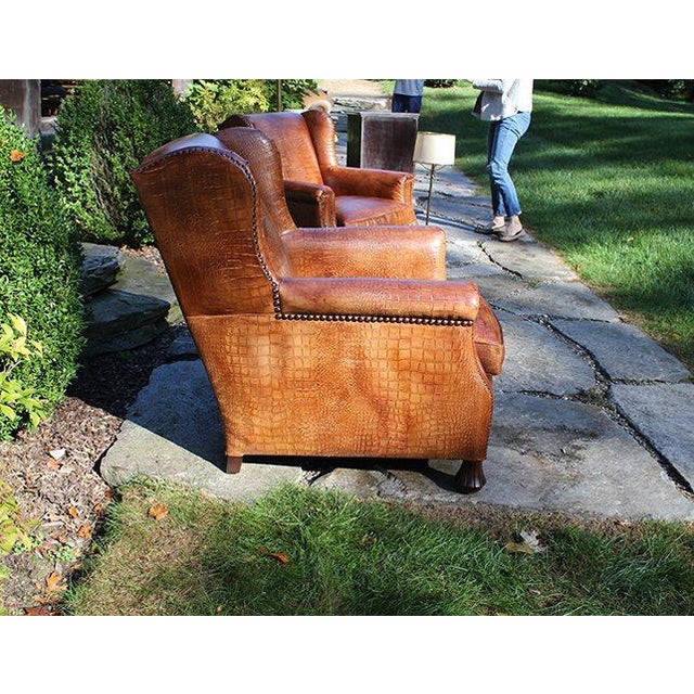 A stunning pair of Hancock & Moore club chairs with a modified wingback silhouette, nailhead trim and upholstered in a...