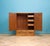 Double doors open to hanging space on the left, with a fitted bank of small drawers and shelving to the right. Large...