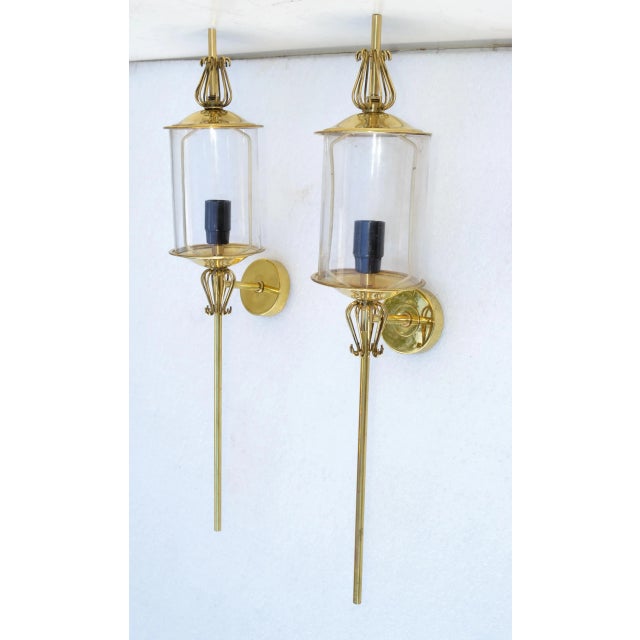 Very unusual and elegant pair of wall lantern sconces by Lunel France Paris. Brass Core with 1 Light Glass Lantern. We...