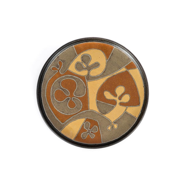 Clyde Burt ceramic charger in glazed stoneware with incised image. Signature to underside: [CB]. American, c. 1965
