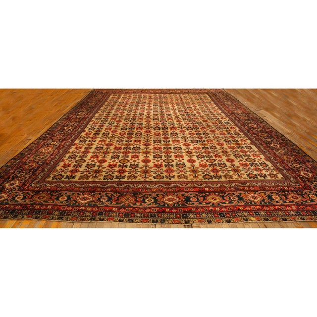 This early 20th-century Antique Mahal Rugs characterized by a relaxed, all-over pattern of stylized floral motifs and a...