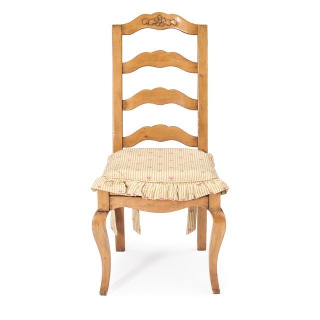 FOUR FRENCH PROVINCIAL-STYLE LADDER-BACK SIDE CHAIRS WITH FOUR MATCHING CUSTOM CUSHIONS INCLUDED Each chair features a...