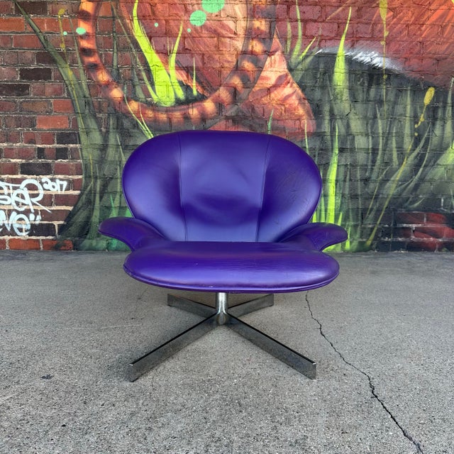 Lounge chair by Ligne Roset featuring purple leather and chrome base.