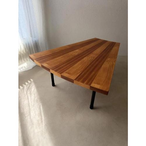 This fan-shaped coffee table from the 1950s is defined by its carefully constructed wooden top. Wide bands of light and...