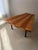 This fan-shaped coffee table from the 1950s is defined by its carefully constructed wooden top. Wide bands of light and...