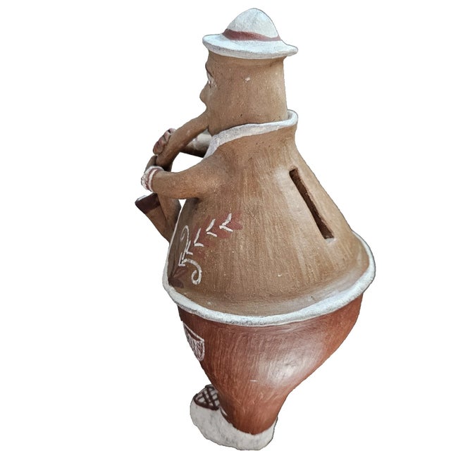 Peruvian Folk Art Pottery Terracotta Clay Sculpture Bank Man Saxophone 8" tall. Item is not signed.