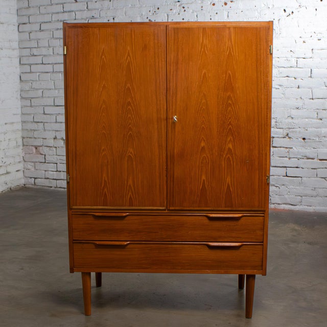 Marvelous vintage Scandinavian Modern storage cabinet, bar, armoire, wardrobe, or gentleman’s chest composed of a petite...