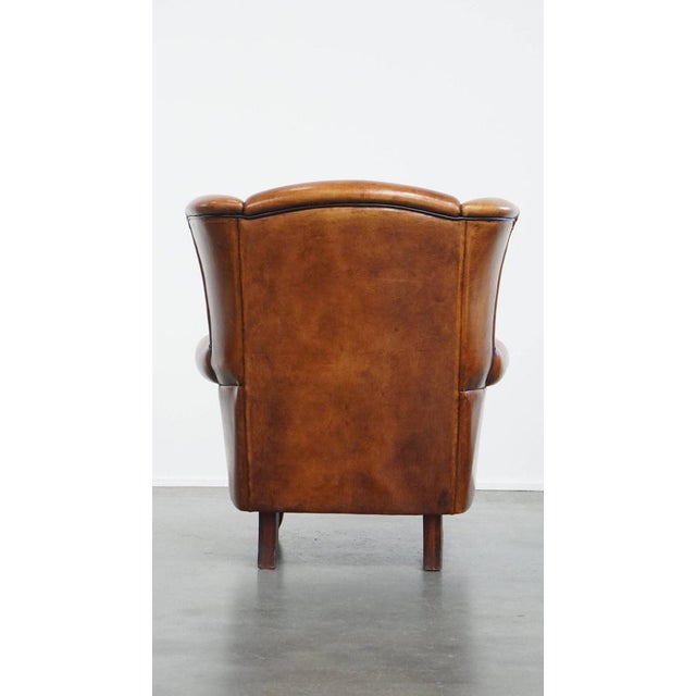 Sheepskin Wing Chair with Warm Colours and Refined Finish with Black Piping For Sale - Image 4 of 13