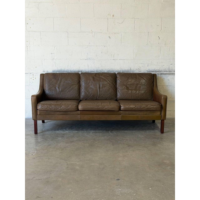 This classic three-seater sofa features a streamlined silhouette with gentle curves and a relaxed seating profile. The...