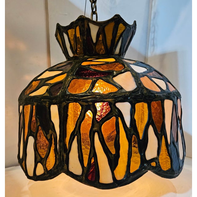First half 20th century, folk art style, domed pendant chandelier having polychrome, stained glass mosaic style shade in...