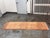 Design Plus Gallery presents a 2ft6in × 8ft8in Vintage Hand Knotted Wool Runner. This wool runner has rust, camel, and...