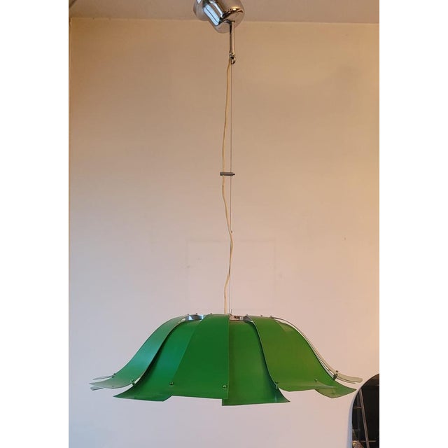 This chandelier has a bold and dynamic design, composed of green repainted metal strips arranged to create an open petal...