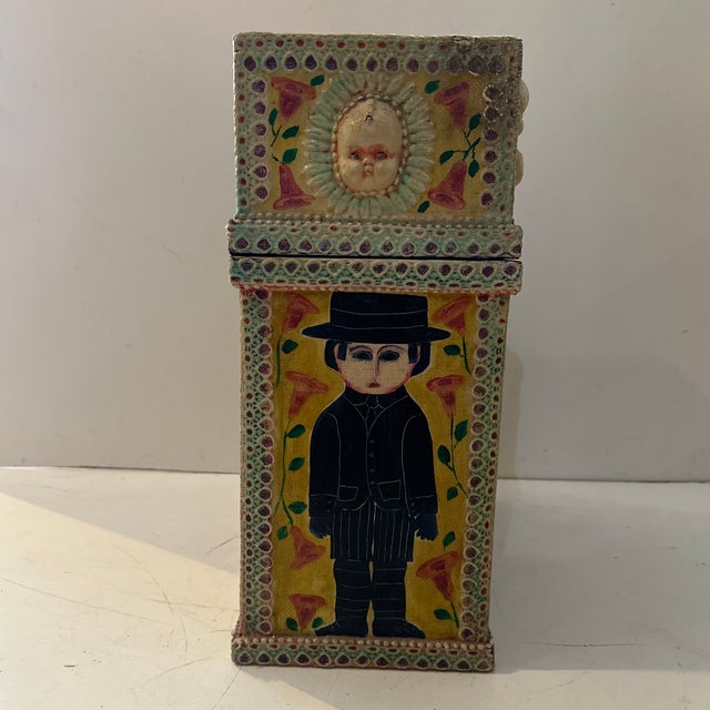 Antique folk art storage box featuring hand‑painted figures and applied doll elements. This one‑of‑a‑kind piece combines...